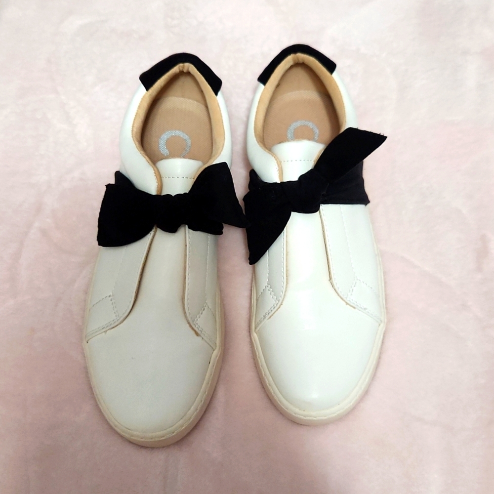 Slip on leather tennis with cute black velvet accent bow.